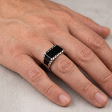 Hand wearing the black geometric ring