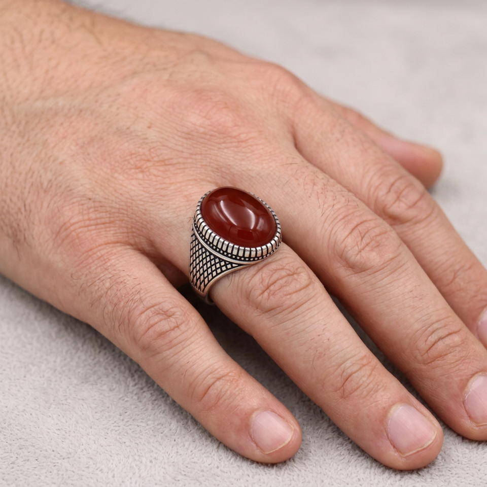 Hand wearing the red-stone lattice ring