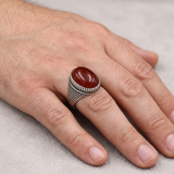 Hand wearing the red-stone lattice ring