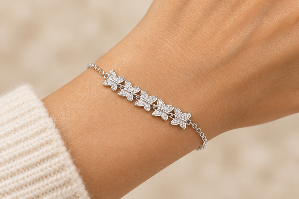 925 sterling silver bracelet with five connected butterfly motifs worn on a hand